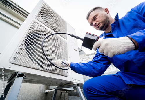 the technician uses a digital camera to check the clogging of the heat exchanger