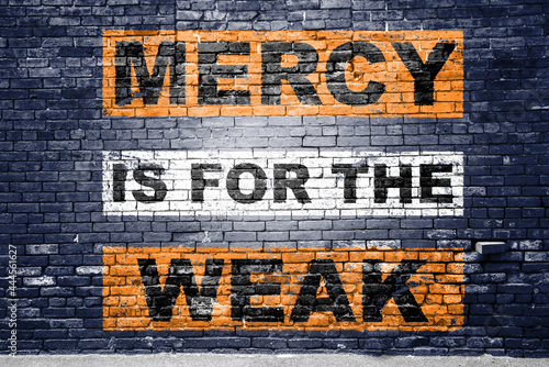 Mercy is for the weak saying lettering Graffiti on Brick Wall