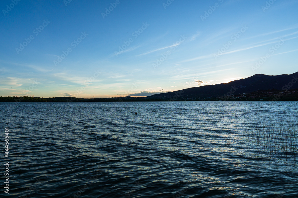 The blue hour on the shores of Lake Pusiano: a small lake in Brianza, Lombardy, Italy - May 2021.