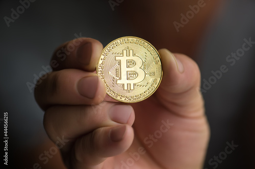 man holding bitcoin in hand closeup