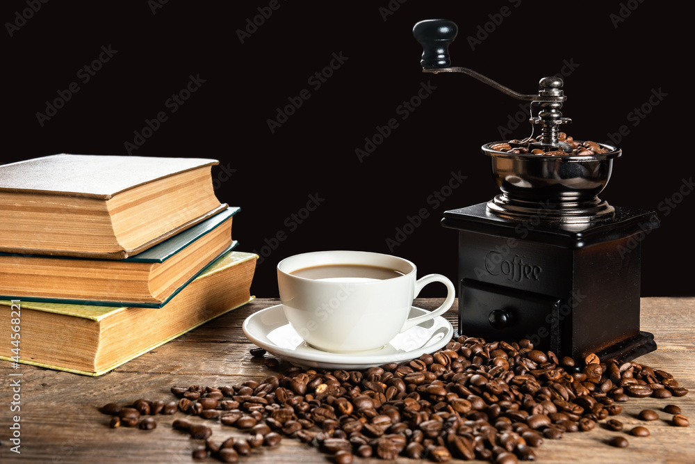 Cup of coffee and heap of beans on a wooden table
