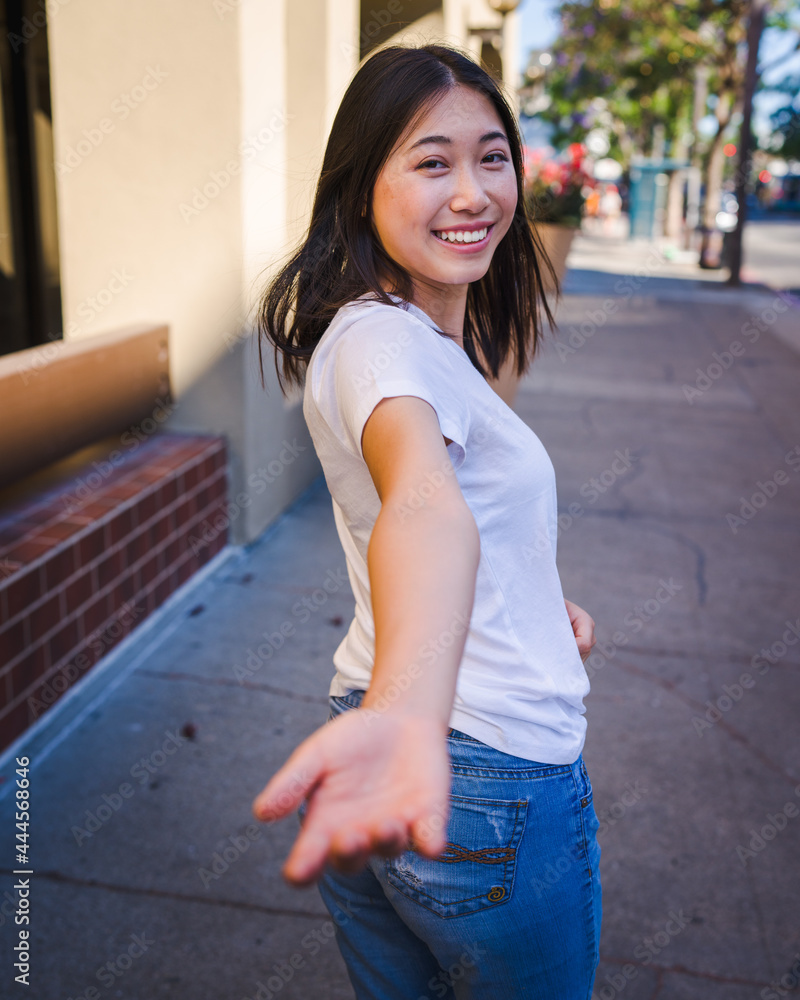 Togetherness, Young Asian Woman Reaching To Hold Hands on a Sidewalk in Downtown San Jose