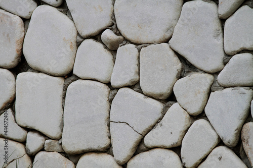 Wall cladding made using white, rounded white stones