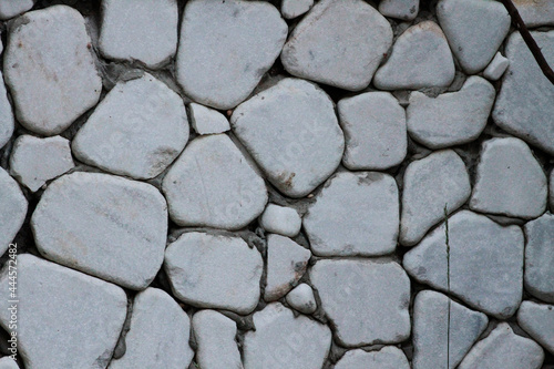 Wall cladding made using white, rounded white stones