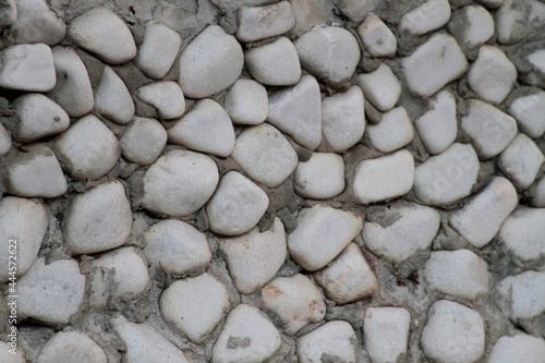 Wall cladding made using white, rounded white stones