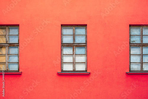 Red house facade with wooden windows