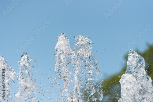 water fountain jets against a blue sky