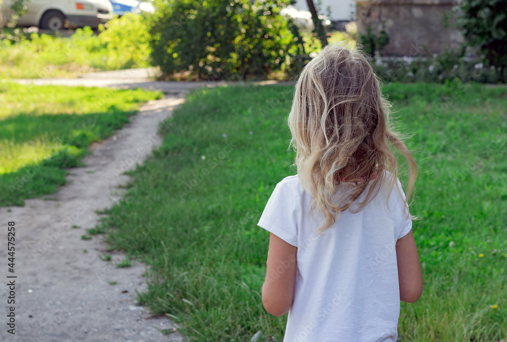 little blonde six years old walks along the path in the park, a portrait of a preschooler, a girl with blond hair, a photo from the back little blonde six years old walks along the path in the park, a portrait of a preschooler, a girl with blond hair, a photo from the back