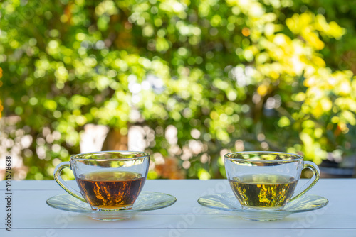 cups of green and chinese tea served on white table in garden