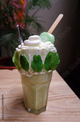 Greentea milkshake topping ice cream on a table photo
