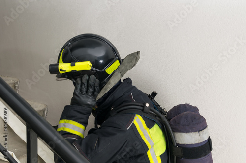 a firefighter in a helmet climbs the stairs, close-up © kurgu128