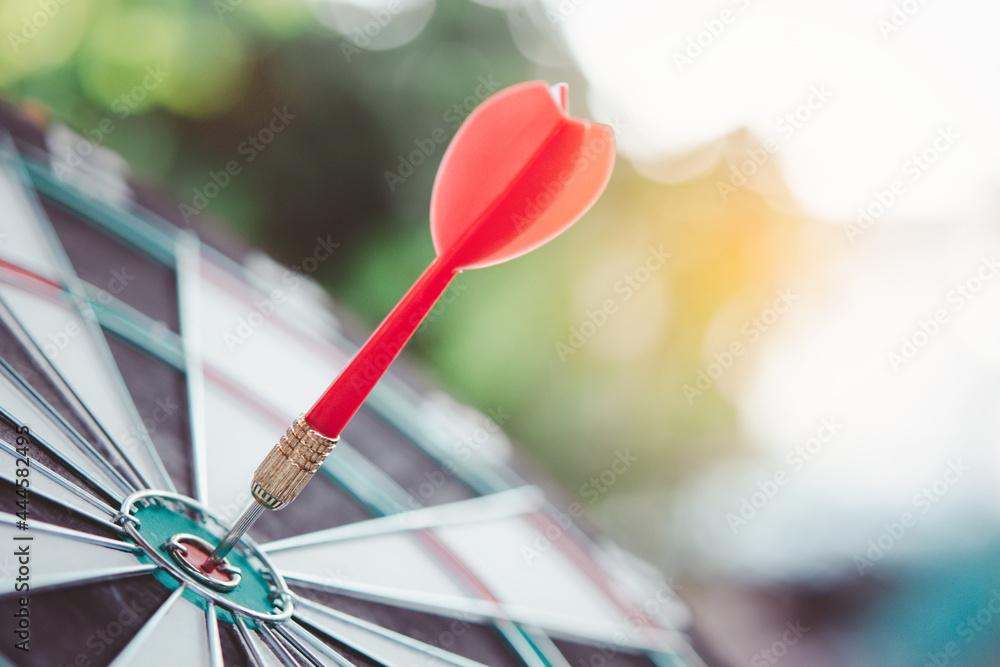 Business marketing success concept. Red dart arrow in center of the target dartboard. Bullseye is a target of business. Business marketing success concept. Red dart arrow in center of the target dartboard. Bullseye is a target of business.