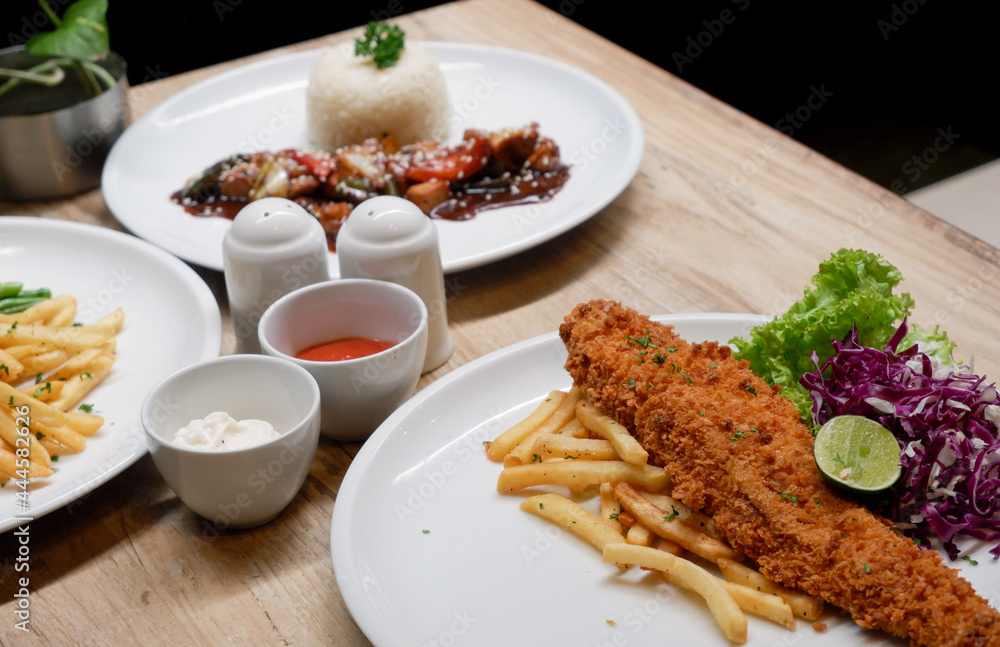 Sirloin steak, catfish and chips, and chicken black pepper. Food menu on the table Sirloin steak, catfish and chips, and chicken black pepper. Food menu on the table