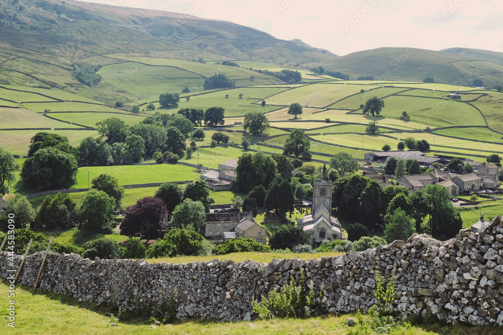 Fototapeta premium A view looking south over towards Burnsall and Thorpe Fell, in the Yorkshire Dales, North Yorkshire.
