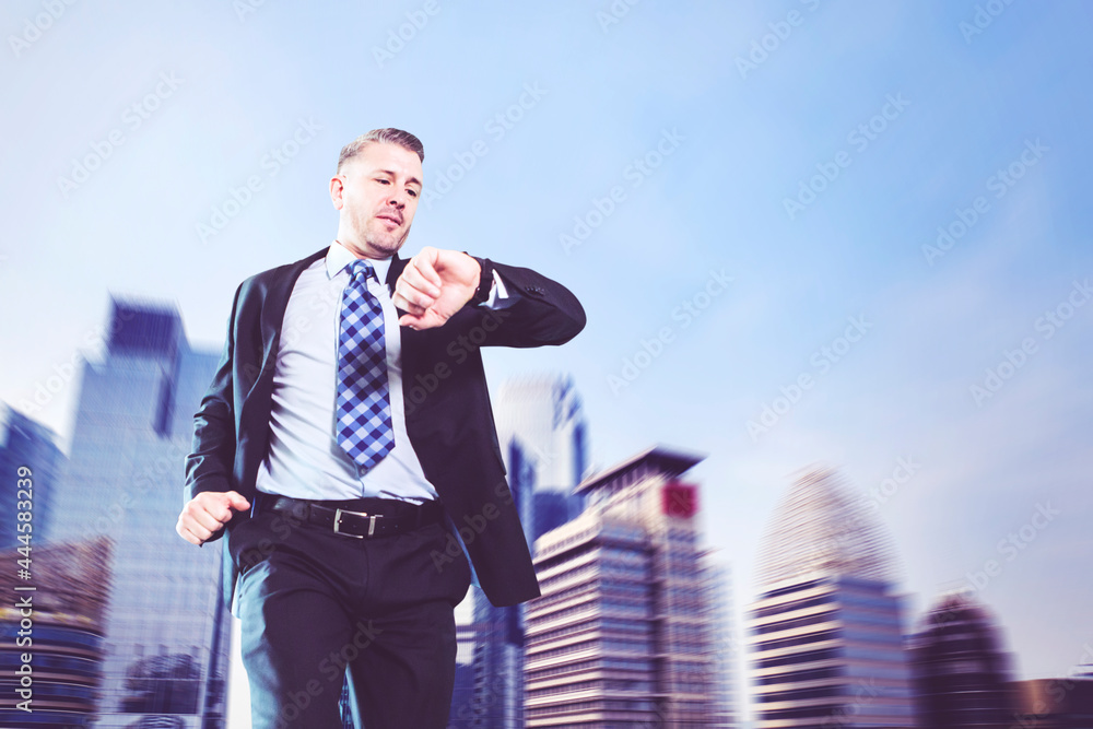 Businessman checking his watch while running fast Businessman checking his watch while running fast