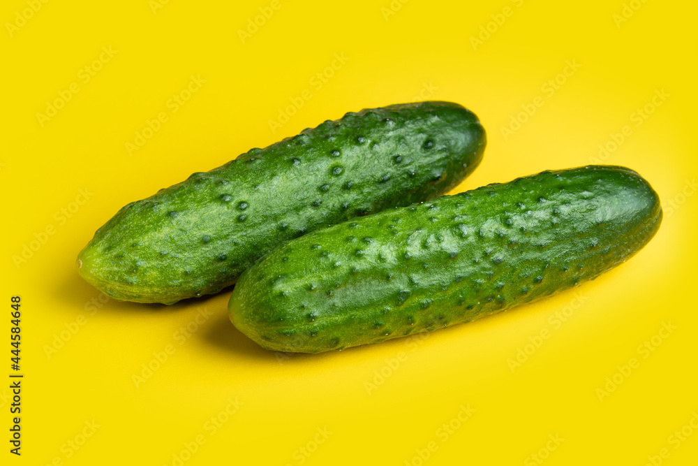 Fresh cucumbers on yellow background. Fresh cucumbers on yellow background.