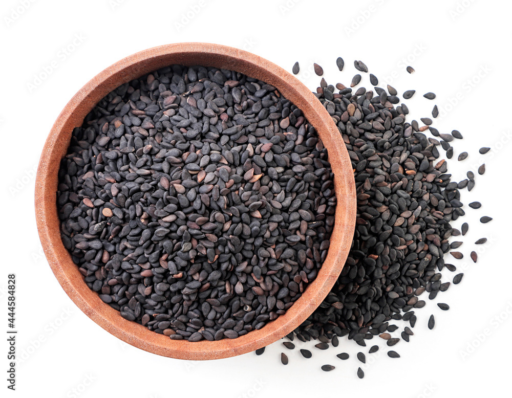Black sesame seeds in a wooden plate on a white background, isolated. Top view Black sesame seeds in a wooden plate on a white background, isolated. Top view