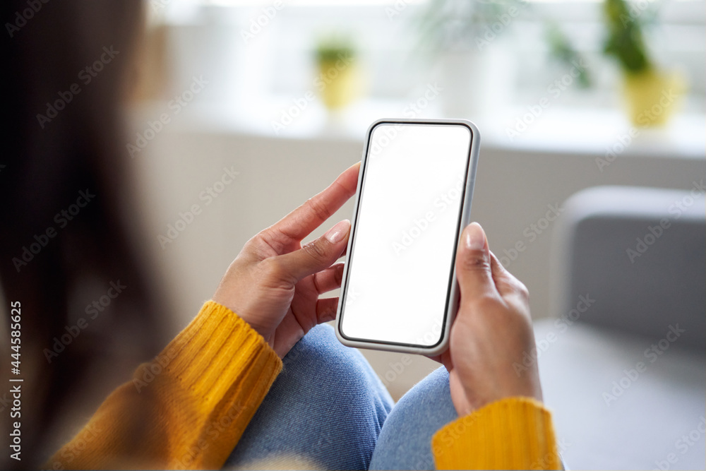Smartphone mockup. Closeup of woman using mobile phone with empty screen at home - obrazy, fototapety, plakaty 
