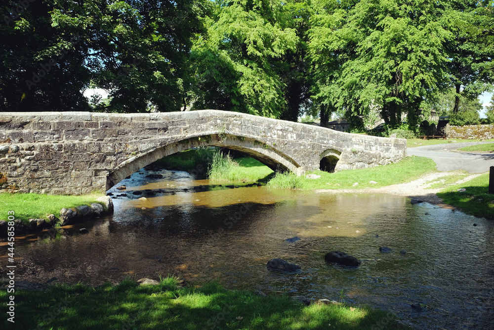 Fototapeta premium The old packhorse bridge over Linton Beck, Yorkshire Dales, UK