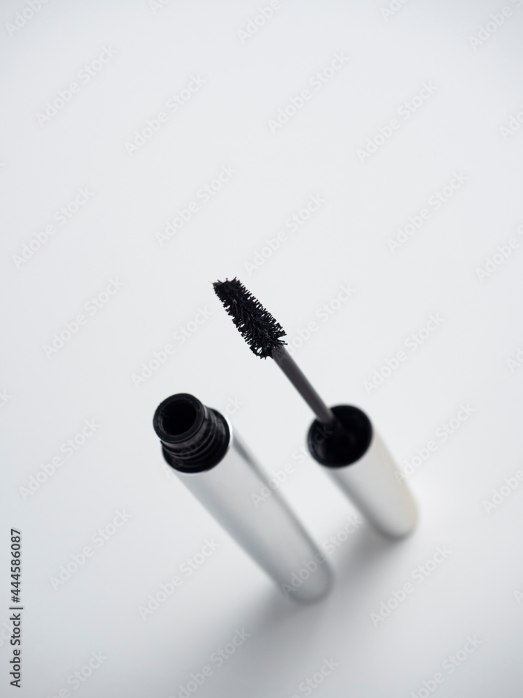 Open mascara isolated on a white background. Cosmetics for women. Brush for applying mascara Open mascara isolated on a white background. Cosmetics for women. Brush for applying mascara