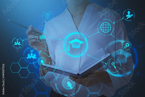 Businesswoman holding an open book and is going to take some notes, pondering about educational prospective in future career, master degree programs in business administration, postgraduate level