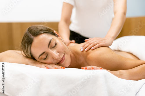 Middle-aged woman having a back massage in a beauty salon.