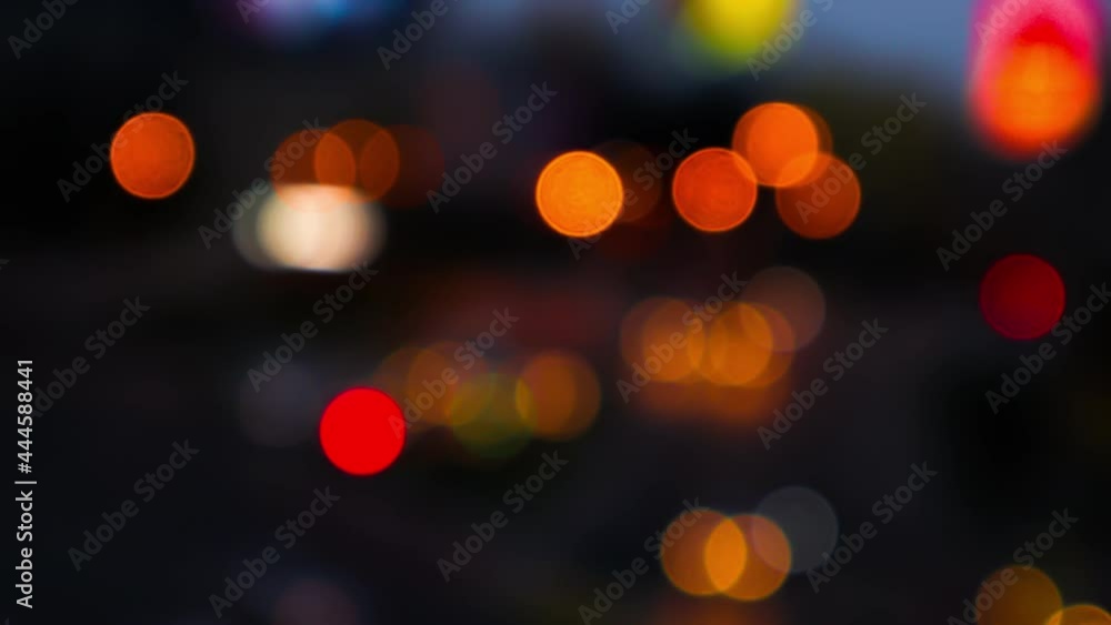 Night road lights blurred bokeh of cars in traffic on the road at night. Abstract bright blurred colored bokeh. Bokeh lights in the city night background Night road lights blurred bokeh of cars in traffic on the road at night. Abstract bright blurred colored bokeh. Bokeh lights in the city night background
