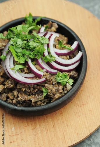  Georgian dish Kuchmachi in a plate with onions 