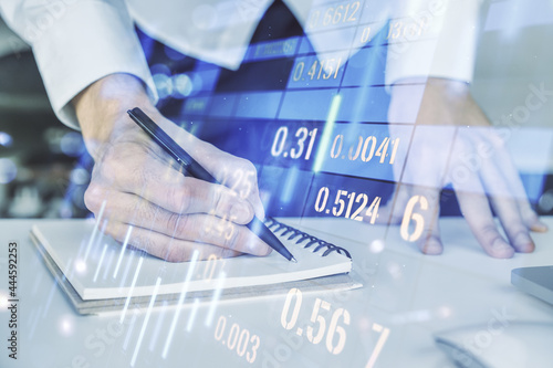 Double exposure of abstract creative financial diagram with hand writing in notebook on background, banking and accounting concept