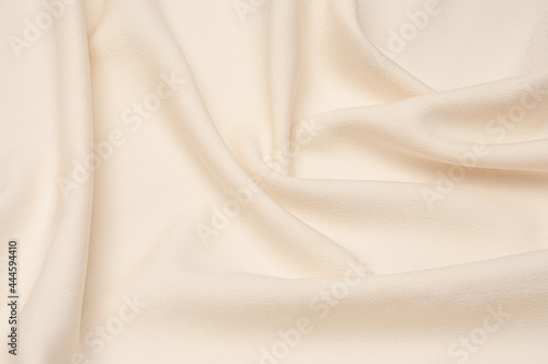 Smooth elegant ivory tissue abstract background. Textile background. Cloth wallpaper. Graphics design element