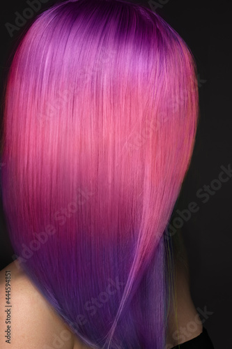 Beautiful woman with multi-colored pink and purple hair .