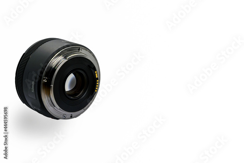 Metal signal contact at the edge of a lens socket to attached with DSLR or mirrorless camera body to communicate together. 50mm lens for portrait photography isolated on a white background