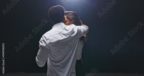 Affectionate, emotional ballroom dance, two lovers follow the rhythm of the music, indulging in a moment of romantic dance, the boy turns his partner in a gentle way, the girl waves her beautiful hair
