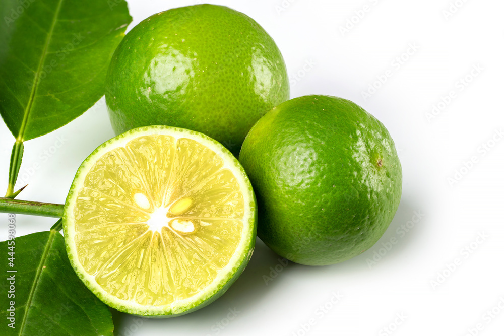 Close up natural fresh lime with sliced, green leaf isolated on white background.