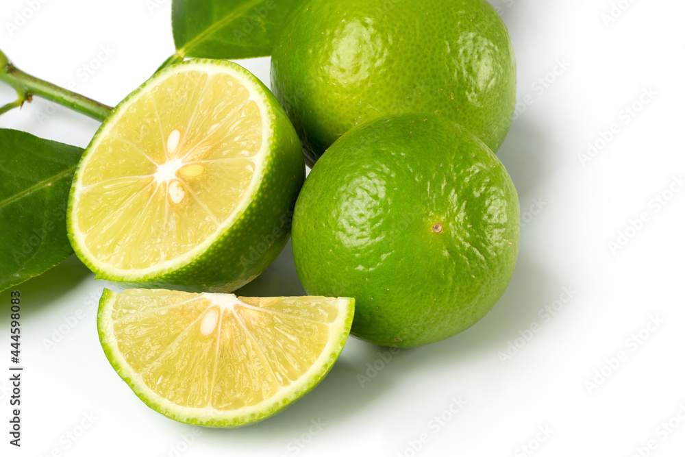 Close up natural fresh lime with sliced, green leaf isolated on white background.. Close up natural fresh lime with sliced, green leaf isolated on white background..