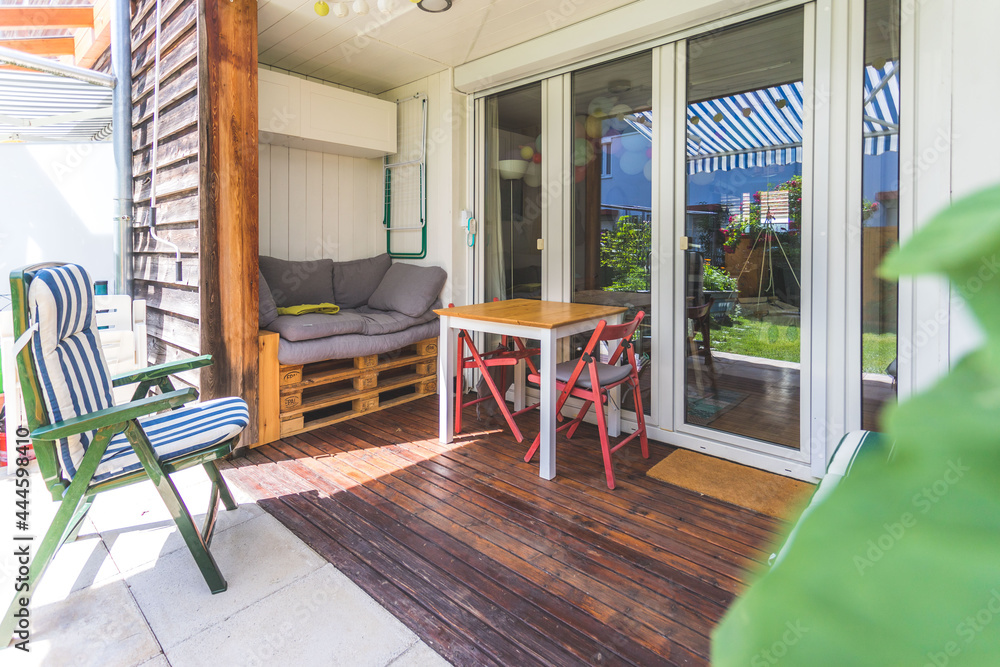 Cozy and homely veranda with little garden, summer time Cozy and homely veranda with little garden, summer time