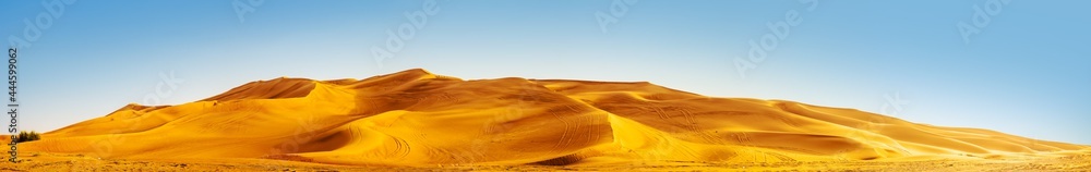 Golden Sand Dune Desert Landscape Panaroma. Beautiful sunset over the sand dunes in the Al Madam Desert, Sharjah, UAE.