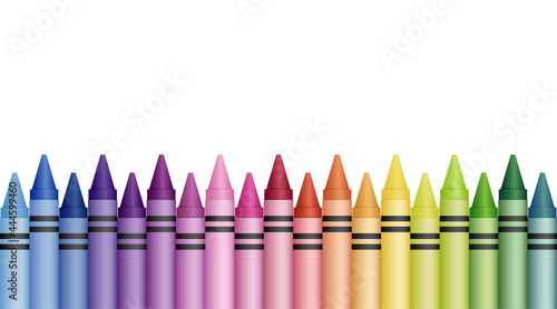 A colorful rainbow gradient of crayons lined up in a staggered row along the bottom of a white background
