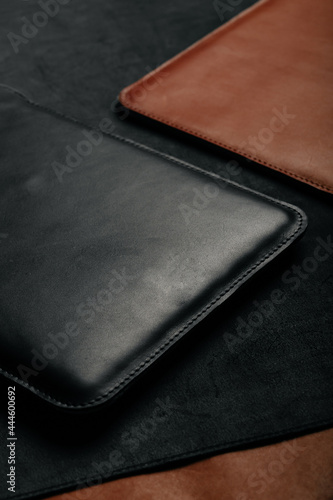 A closeup of handmade black leather laptop case in the studio