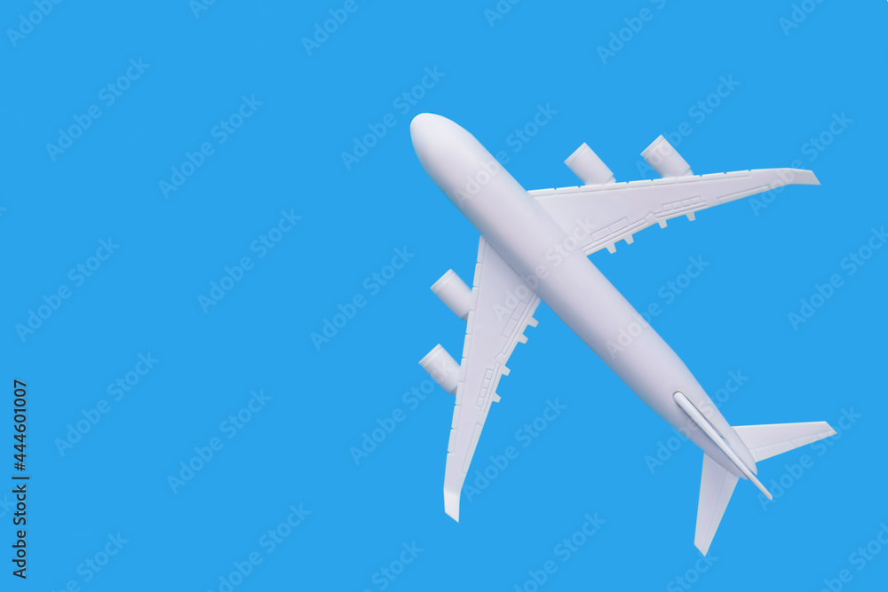 model of passenger plane on blue background.Travel concept