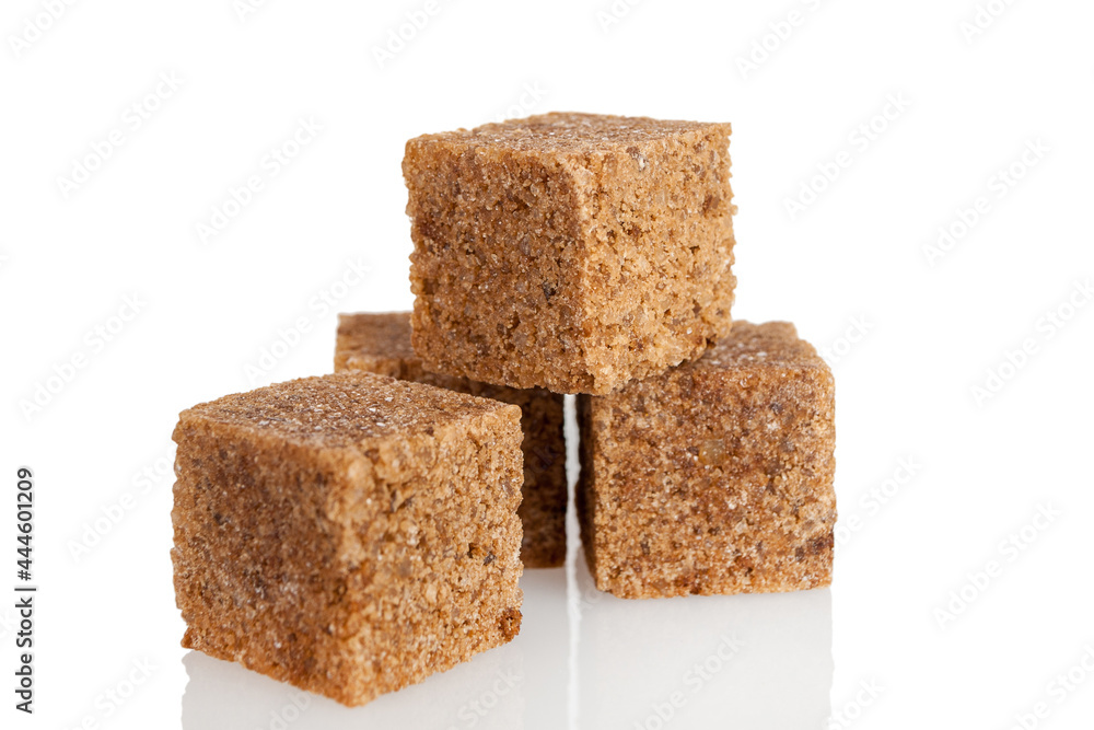 Brown dark sugar produced from cane, refined cubes, isolated on a white background Brown dark sugar produced from cane, refined cubes, isolated on a white background