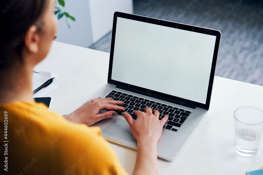 Woman working on laptop mock-up with blank copy space screen Woman working on laptop mock-up with blank copy space screen