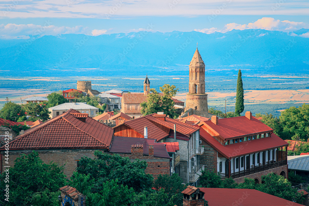 Obraz premium View of Sighnaghi in winery region of Georgia, Kakheti, during sunset in summer with Caucasus mountains in the background