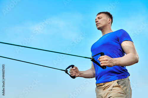 athletic man against blue sky