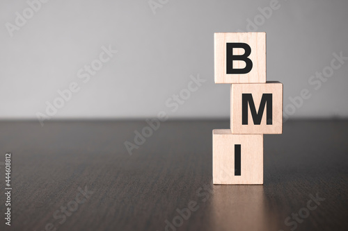 Businesswoman made word bmi with wood building blocks. photo