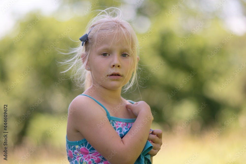 Summer portrait of a little girl in nature.