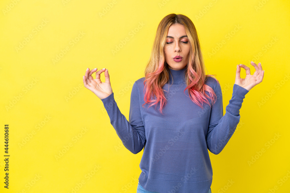 Young woman over isolated yellow background in zen pose Young woman over isolated yellow background in zen pose