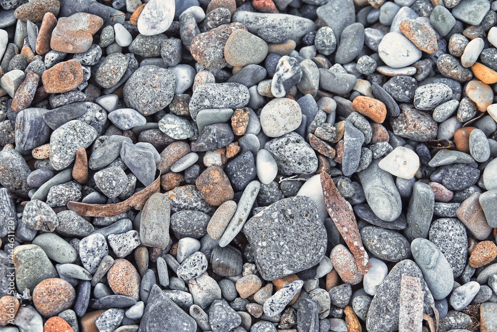 small colored pebbles on the beach. Pebble background on the beach small colored pebbles on the beach. Pebble background on the beach
