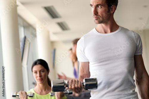 Group of people training in gym together
