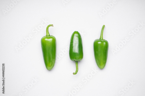 Green chili pepper. Group of jalapeno peppers on a white background, top view.